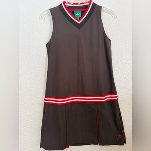 New with tags, Adidas brown w/ red & white stripe golf dress. 1 zip front pocket